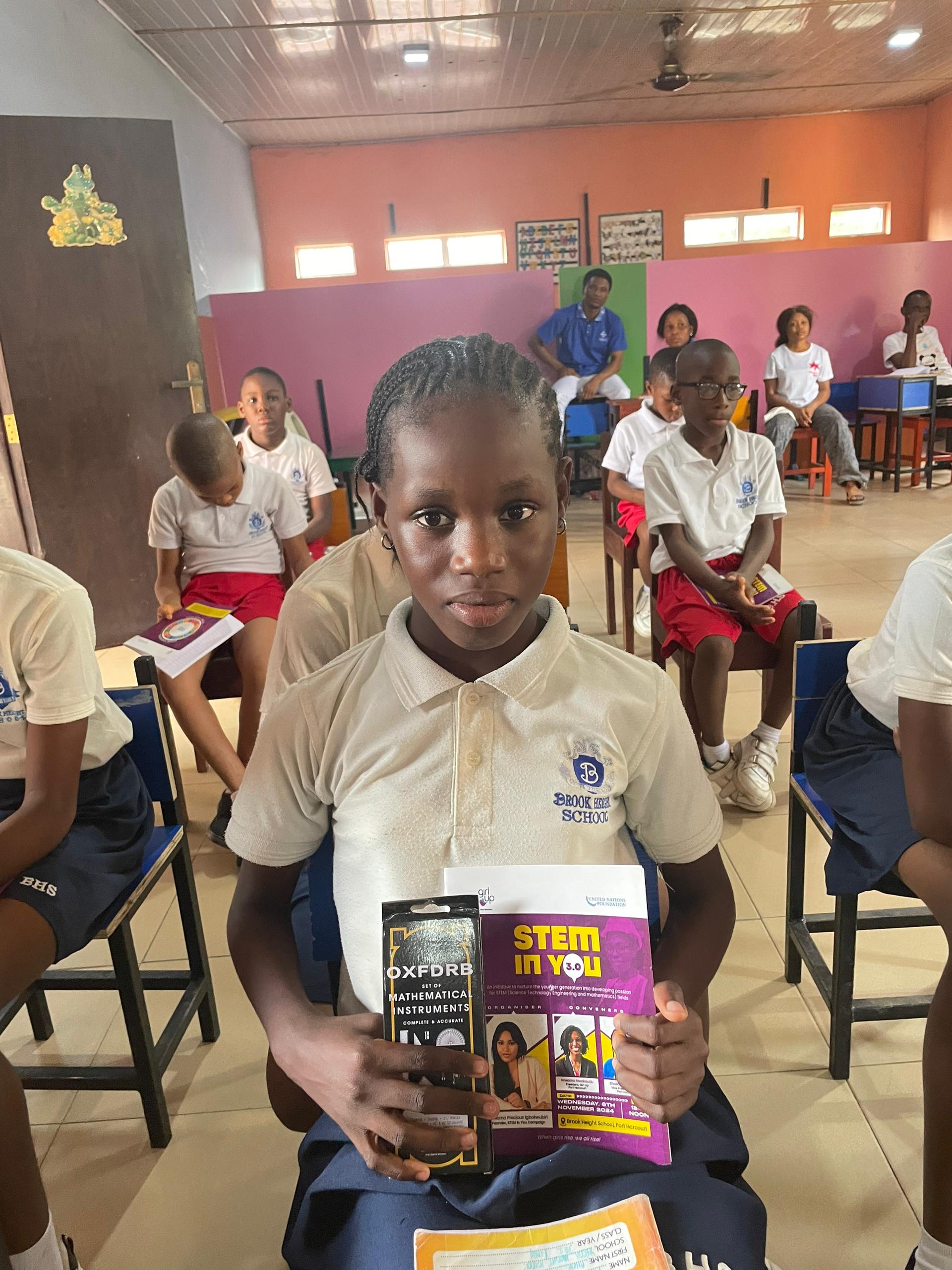 Girl at Brook Height School with STEM IN YOU souvenirs